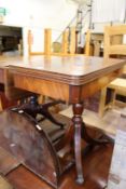 A reproduction mahogany foldover card table