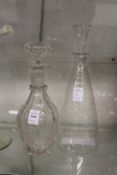 A good cut glass decanter engraved with grapes and vines together with a star cut decanter