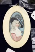 A small oval portrait miniature of a lady wearing a hat