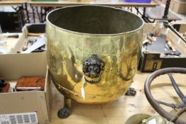 A large brass coal or log basket on lions paw feet