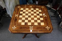 An inlaid games table on tripod base