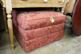 An upholstered box ottoman