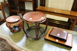 A Chinese barrel shaped hardwood small stand and three other stands