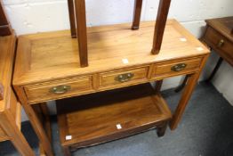 A Chinese three drawer side table