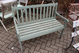 A green painted wooden garden bench