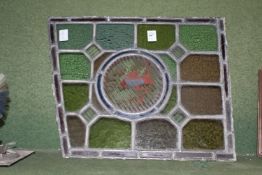 A stained glass and painted window pane