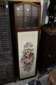 A mahogany folding dressing screen with part glazed and embroidered panels