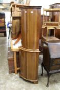 A mahogany standing four door corner cupboard