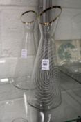 A pair of etched glass carafs