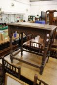 A carved oak occasional table