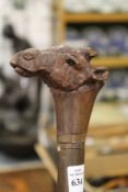 A hardwood walking stick the handle carved as a camels head