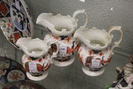 A graduated set of three imari decorated pottery jugs from the Murray collection