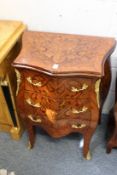 A pair of French style inlaid and ormolu mounted three drawer petit commodes