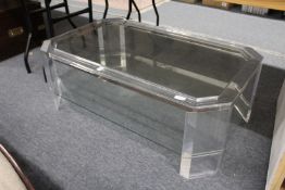 A stylish modern perspex and glass two tier coffee table