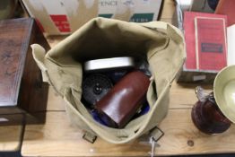 An old army bag containing fishing equipment