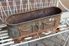 A cast iron garden trough