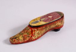 AN UNUSUAL PERSIAN LACQUER PAPIER MACHE SHOE SHAPED SNUFF BOX, The top with the view of a figure,