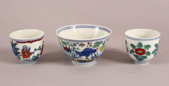 A SMALL GROUP OF MING STYLE DOUCAI CUPS, comprising one tea cup and two smaller ones, larger 9cm