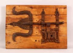 A LARGE 17TH CENTURY ISLAMIC IRON LOCK, 56cm x 40cm.