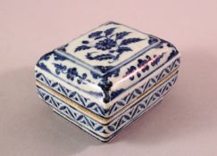 A CHINESE MING STYLE BLUE & WHITE PORCELAIN BOX & COVER - decorated with flora, base with a six