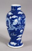 A 19TH / 20TH CENTURY CHINESE BLUE & WHITE PORCELAIN DRAGON VASE - with two dragons chasing the
