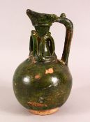 A GREEN GLAZED POSSIBLY UMAYYAD POTTERY EWER, the neck with moulded loop decoration, 22cm high.