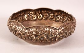 AN INDIAN SILVER BOWL, with embossed and chased floral decoration, 18cm diameter.