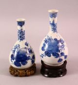 TWO CHINESE BLUE & WHITE PORCELAIN VASES & STANDS, each with floral & fruit decoration, each with