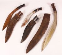 A COLLECTION OF THREE 19TH CENTURY NEPALESE KUKRI DAGGERS in leather scabbards, largest 53cm long.