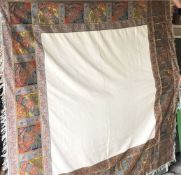 A EUROPEAN WOVEN SILK TURNOVER SHAWL, cream central panel within an embroidered border with