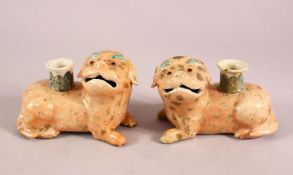 A PAIR OF 19TH / 20TH CENTURY CHINESE FAMILLE ROSE DOG CANDLESTICKS, each dog recumbent with the