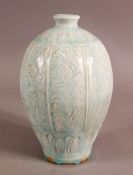 A CHINESE SONG STYLE CARVED CELADON PORCELAIN VASE, decorated with panels of flora, 19.5cm high.