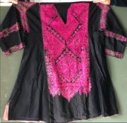 A 20TH CENTURY ETHNIC EMBROIDERED COTTON BLACK AND PINK DRESS, possibly Swat Valley, 48in waist x