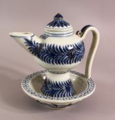 A CHINESE BLUE AND WHITE TEAPOT, painted with bands of foliate decoration, the base with built in