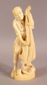 A FINE QUALITY JAPANESE MEIJI PERIOD CARVED IVORY OKIMONO OF A FISHERMAN, one-piece carving, the