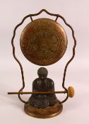 A CHINESE BRONZE BUDDHA ORNAMENT WITH BRASS GONG AND MALLET, 32cm high.