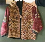 AN ETHNIC EMBROIDERED SHORT JACKET, constructed from laos weavings of geometric design, cotton