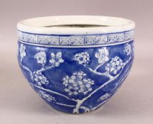 A SMALL CHINESE BLUE AND WHITE PORCELAIN PLANTER, decorated with prunus blossom, 15.5cm high, 20cm