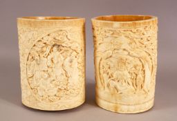 A GOOD PAIR OF 19TH / EARLY 20TH CENTURY CHINESE CARVED IVORY BRUSH POTS - Each pot carved with an