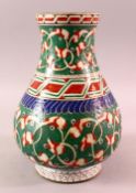 A TURKISH OTTOMAN 18TH CENTURY IZNIK VASE, with green and red motif decorations, 26cm