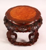 A FINE 19TH CENTURY CHINESE HARDWOOD CARVED STAND - with a burr wood inset top, the body carved with