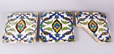 A SET OF THREE EARLY SAFAVID POTTERY TILES, each with the same decoration, white ground ith blue