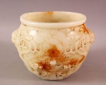 A CARVED HETIAN JADE TWIN HANDLED BOWL, the body carved with dragons, 14cm high, 19cm diameter.