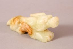 A CHINESE WHITE JADE CARVING in the form of an animal, 10cm long.`