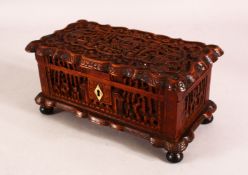 A 19TH CENTURY CHINESE CARVED WOODEN CANTON LIDDED BOX - the box carved with deep relief depicting