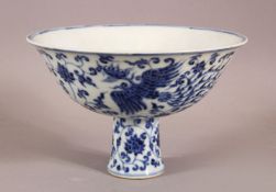 A CHINESE BLUE AND WHITE STEM CUP, the bowl painted with phoenix, six character mark to inner,