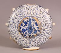A GOOD TURKISH IZNIK POTTERY WATER FLASK - decorated with scrolling foliage and flora 18cm high .