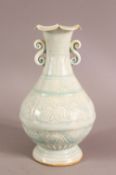 A SONG STYLE CELADON PETAL SHAPED PORCELAIN VASE - with twin handles and carved decorations, 20cm