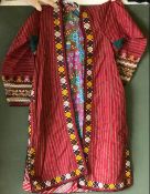 A LONG EMBROIDERED TEKKE COAT, 20th Century, with floral lining and embroidered decoration,
