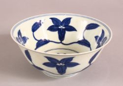 A CHINESE CHENHUA STYLE BLUE AND WHITE PORCELAIN BOWL, painted with flowers, 15.5cm diameter.